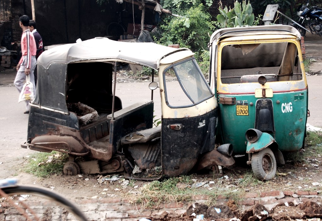 Battered autorickshaws in India. Photo by Guy Bergstrom.