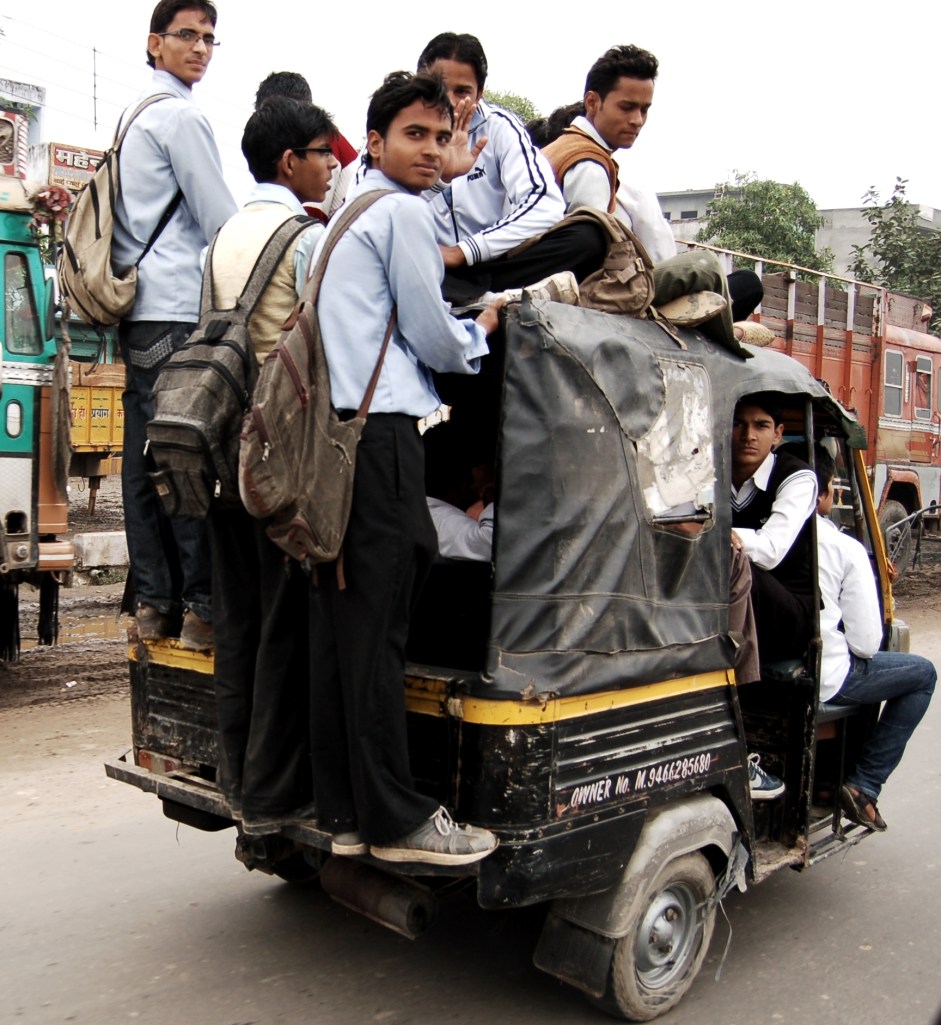 I counted about 15 students inside, on top or hanging from the back of this auto-rickshaw. It's the Indian version of a cab, with three wheels and a lot more excitement than boring Yellow Cabs back home. With the right driver, an autorickshaw ride can be like a Formula One race through side streets and packed traffic. Photo by Guy Bergstrom.