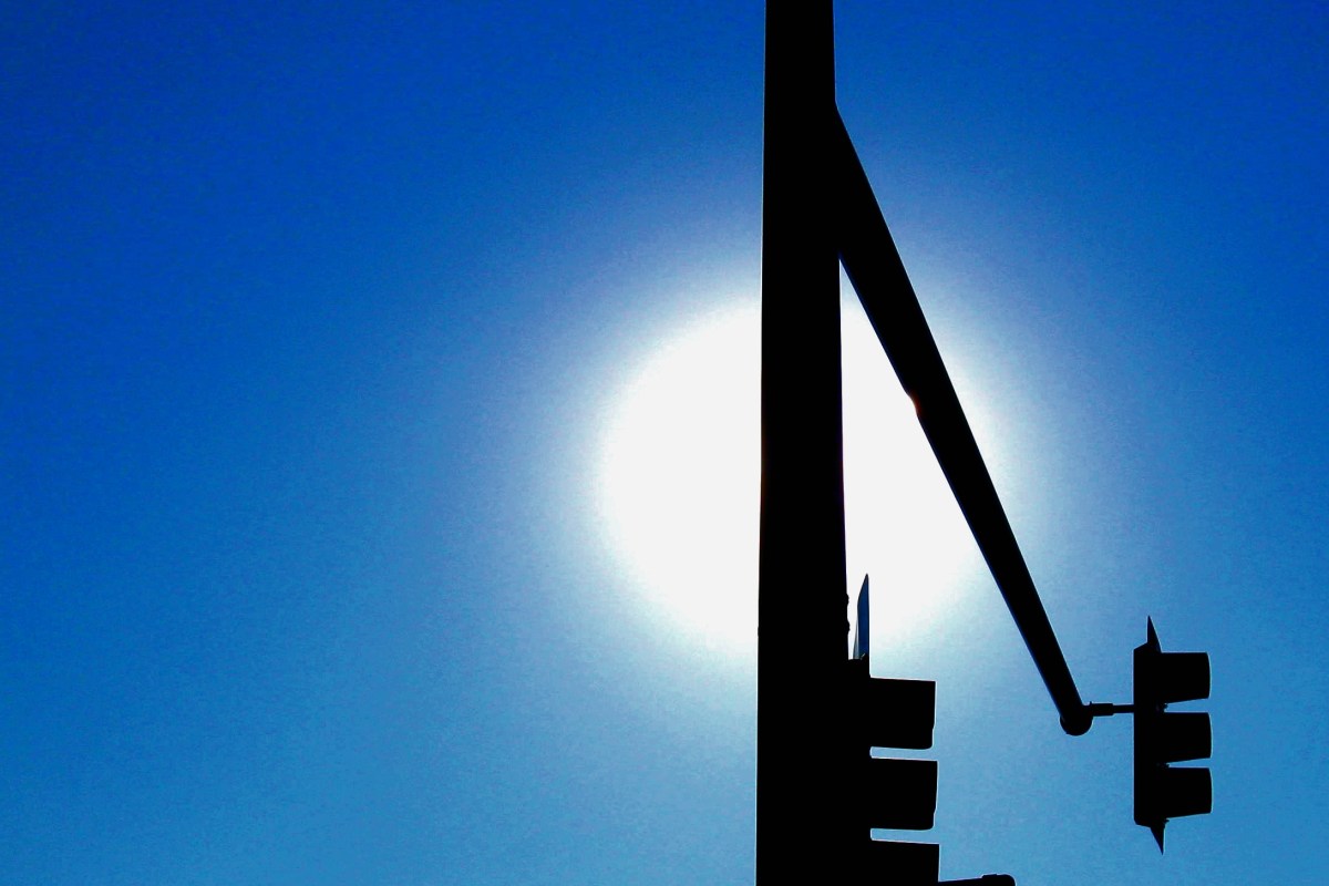 This is just a stop sign in Denver and the sun. But somehow, it's more than that. Photo by Guy Bergstrom.