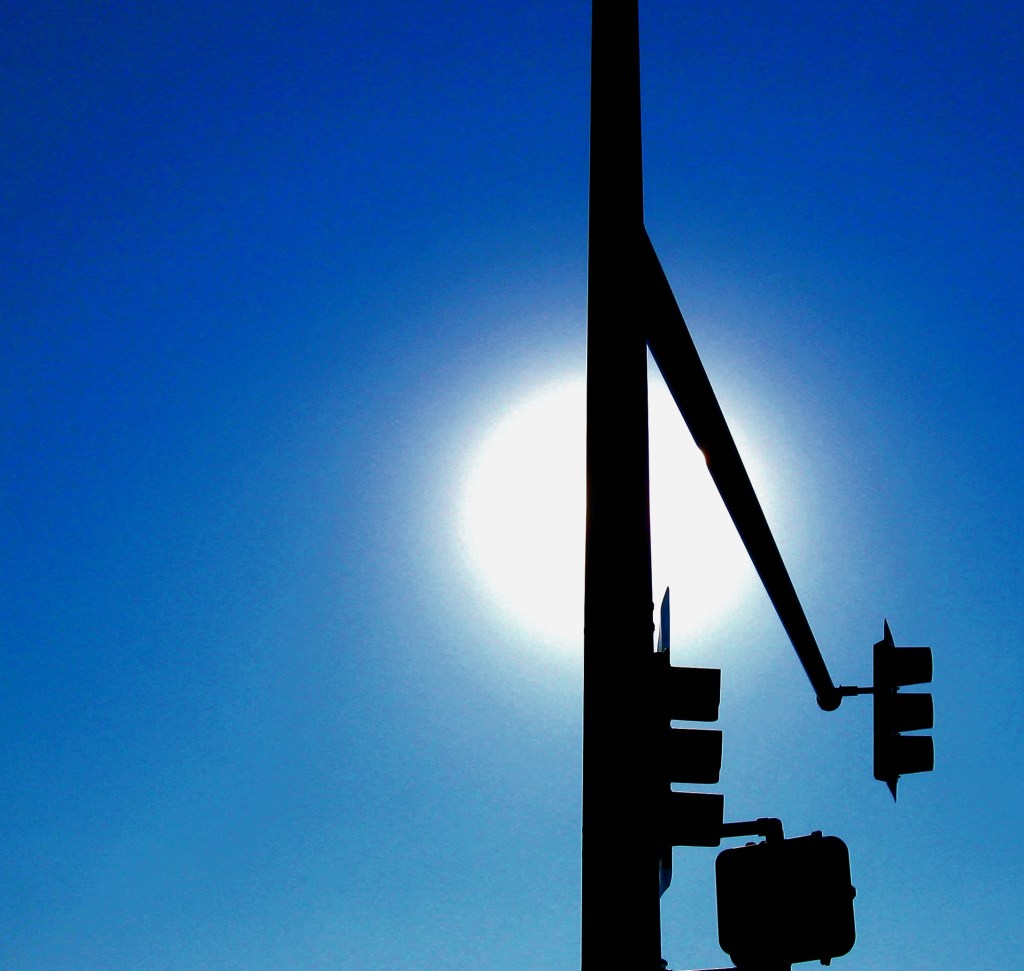 This is just a stop sign in Denver and the sun. But somehow, it's more than that. Photo by Guy Bergstrom.